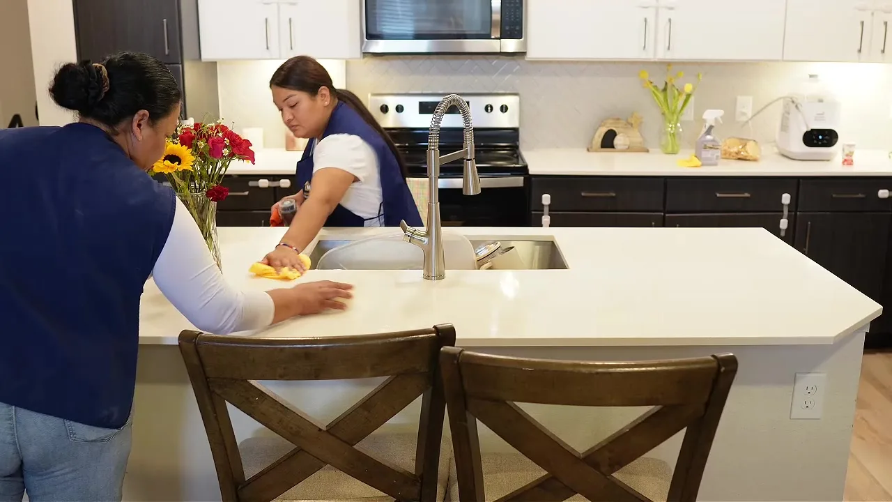 Cleaner wiping a kitchen counter